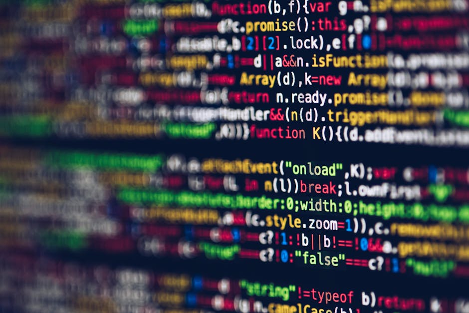 A close-up image of a computer screen displaying a colorful, blurred code editor with lines of programming code in various colors including red, green, yellow, blue, and white. The code appears to be 